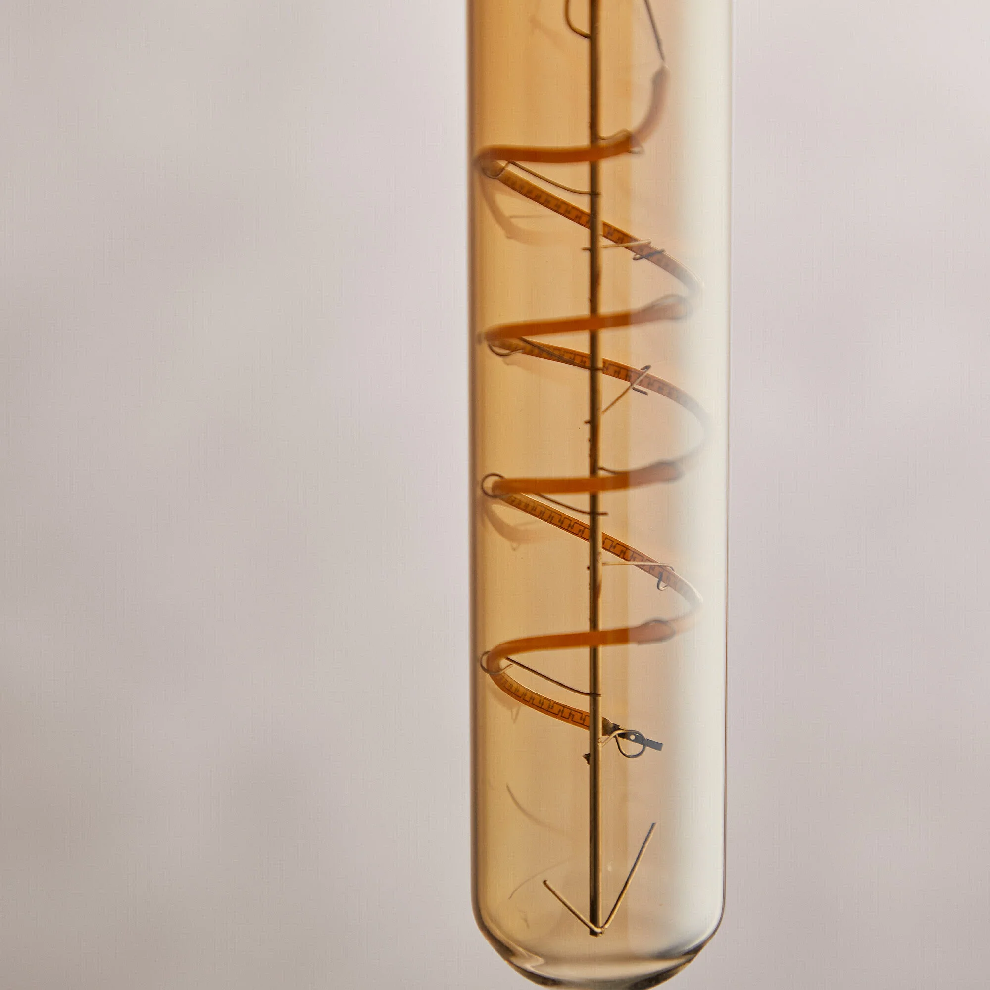 Long thin 4 watt LED curled filament bulb with amber coating and E27 fitting - Image 3