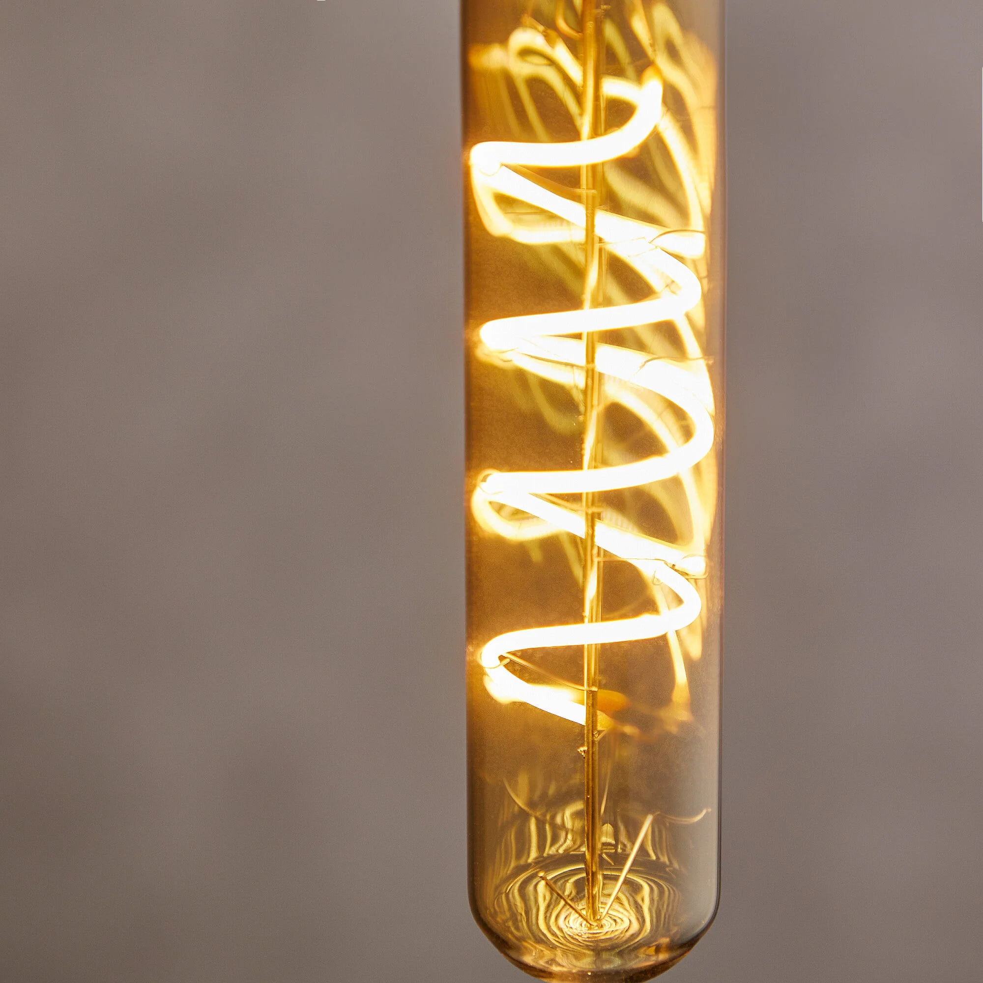 Long thin 4 watt LED curled filament bulb with amber coating and E27 fitting - Image 4